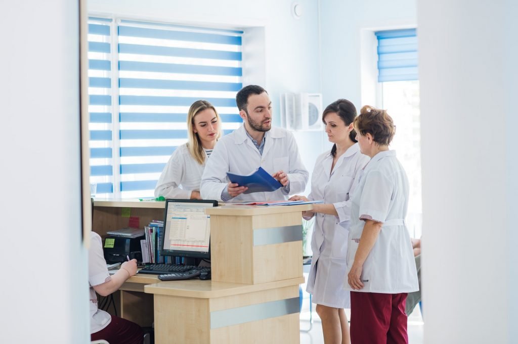 Doctor and receptionist at reception in a hospital